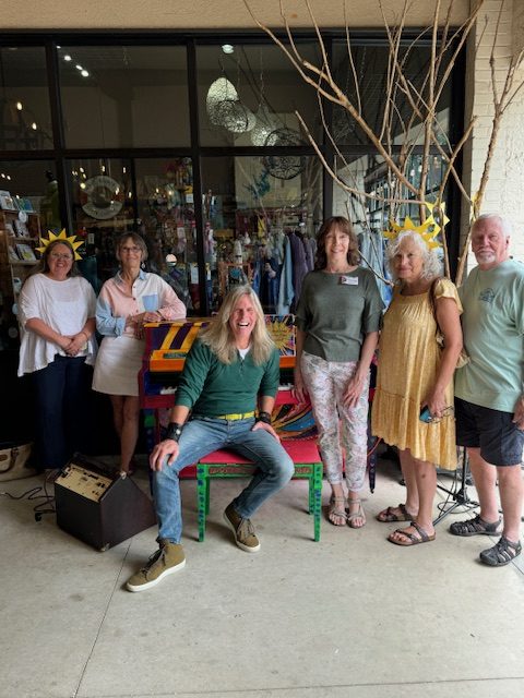 Group of people around a piano