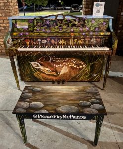 Piano painted with flora and fauna theme and baby deer