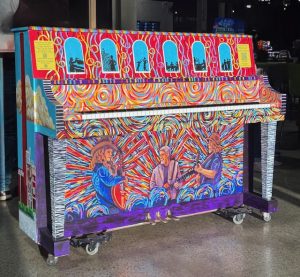 Piano painted to reflect textile mill history and rock and roll