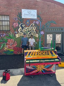Painted piano in front of mural in Easley South Carolina