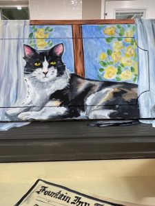 Image of cat painted on a piano