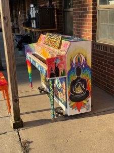 Side view of painted piano in enlightenment theme