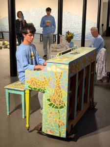 Man plays painted piano